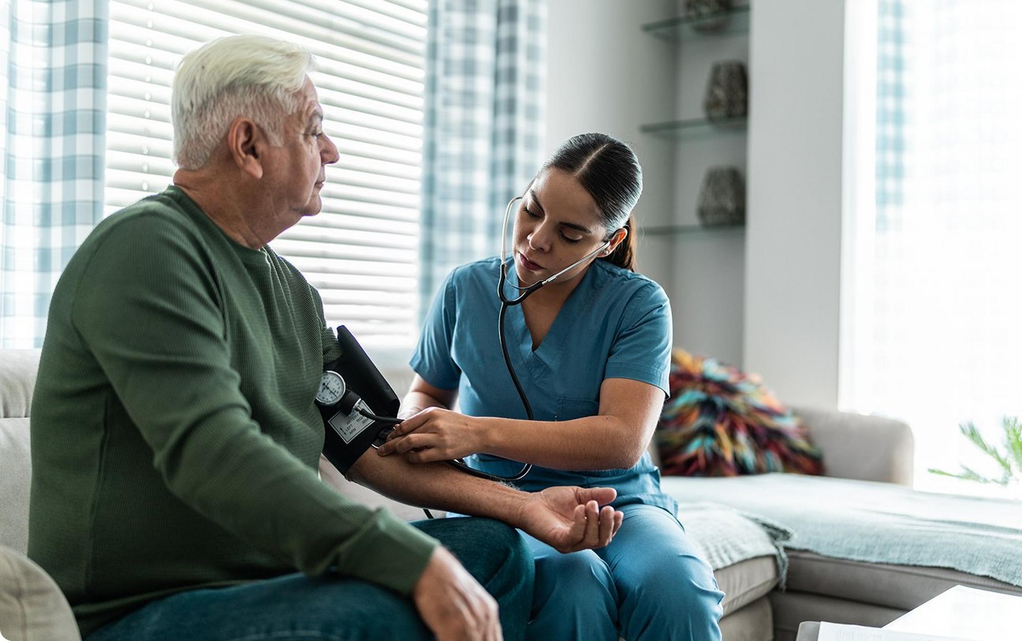 man having nurse take blood pressure