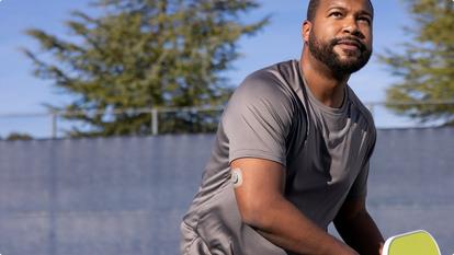 man playing pickleball wearing Stelo biosensor