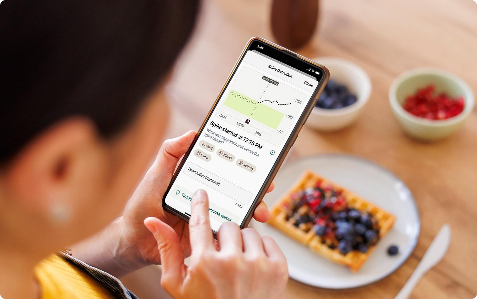person on stelo phone app eating breakfast
