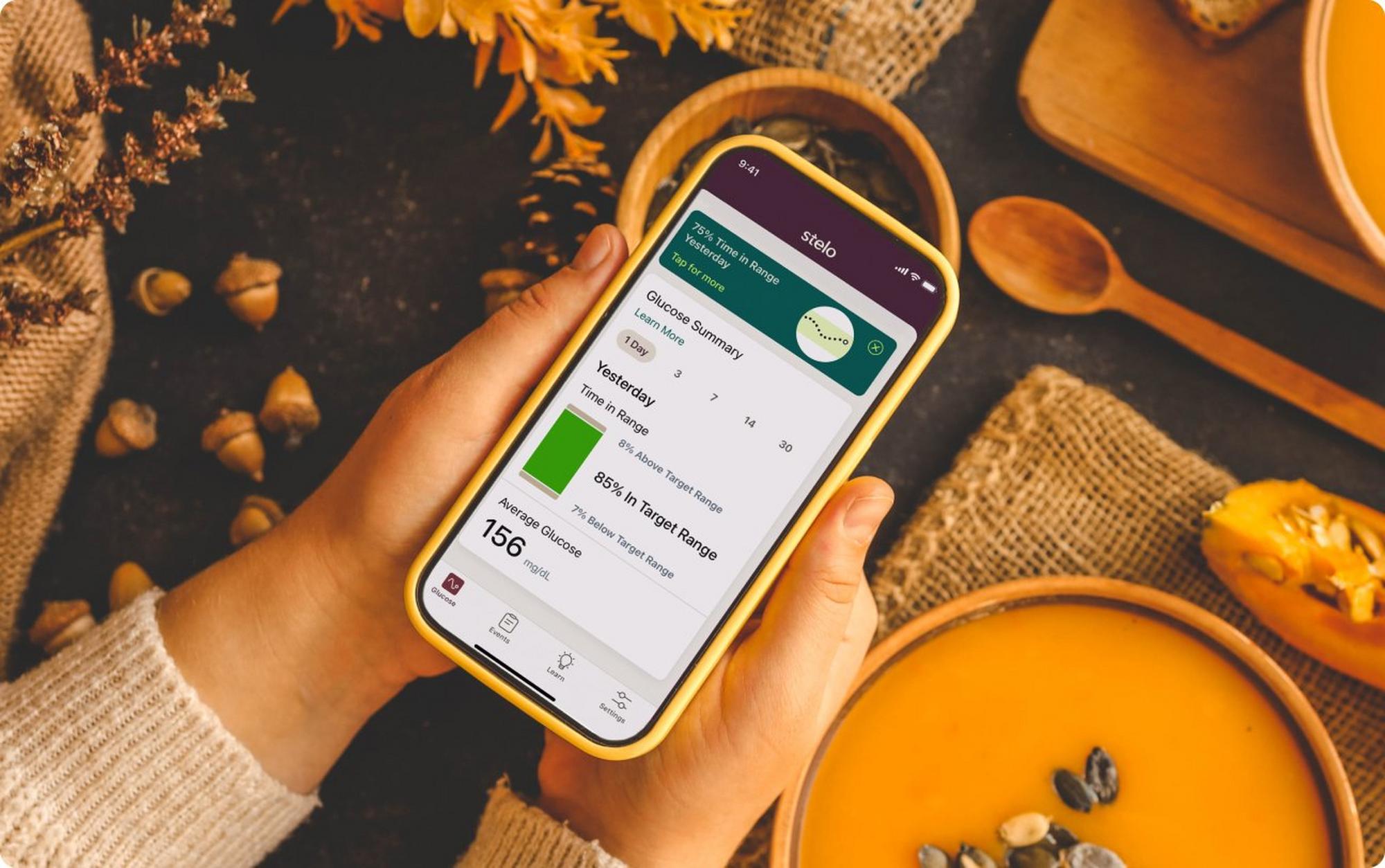 Hands holding smartphone with Stelo app