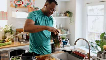 Man in kitchen making smoothie