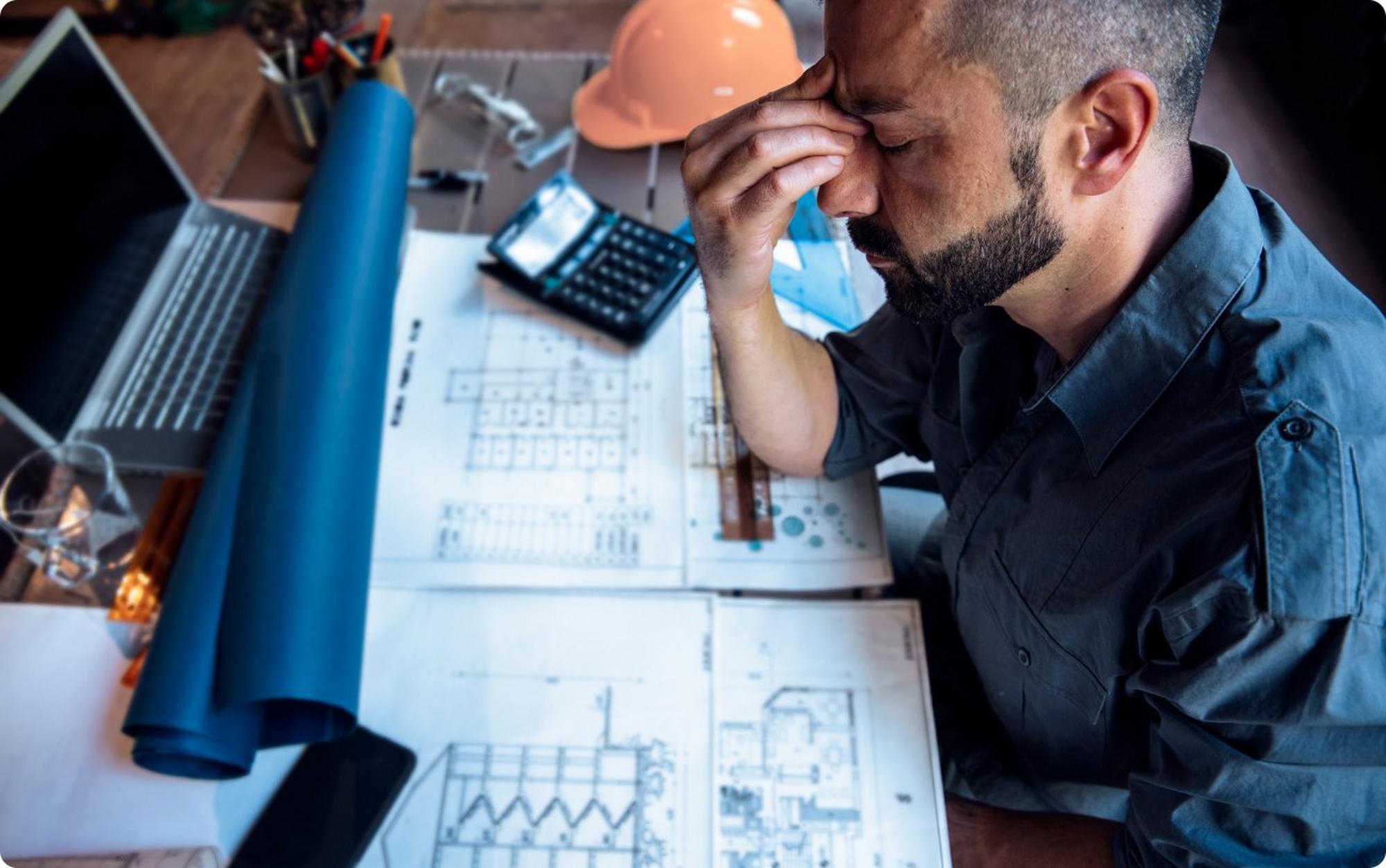 Man with headache sitting at desk
