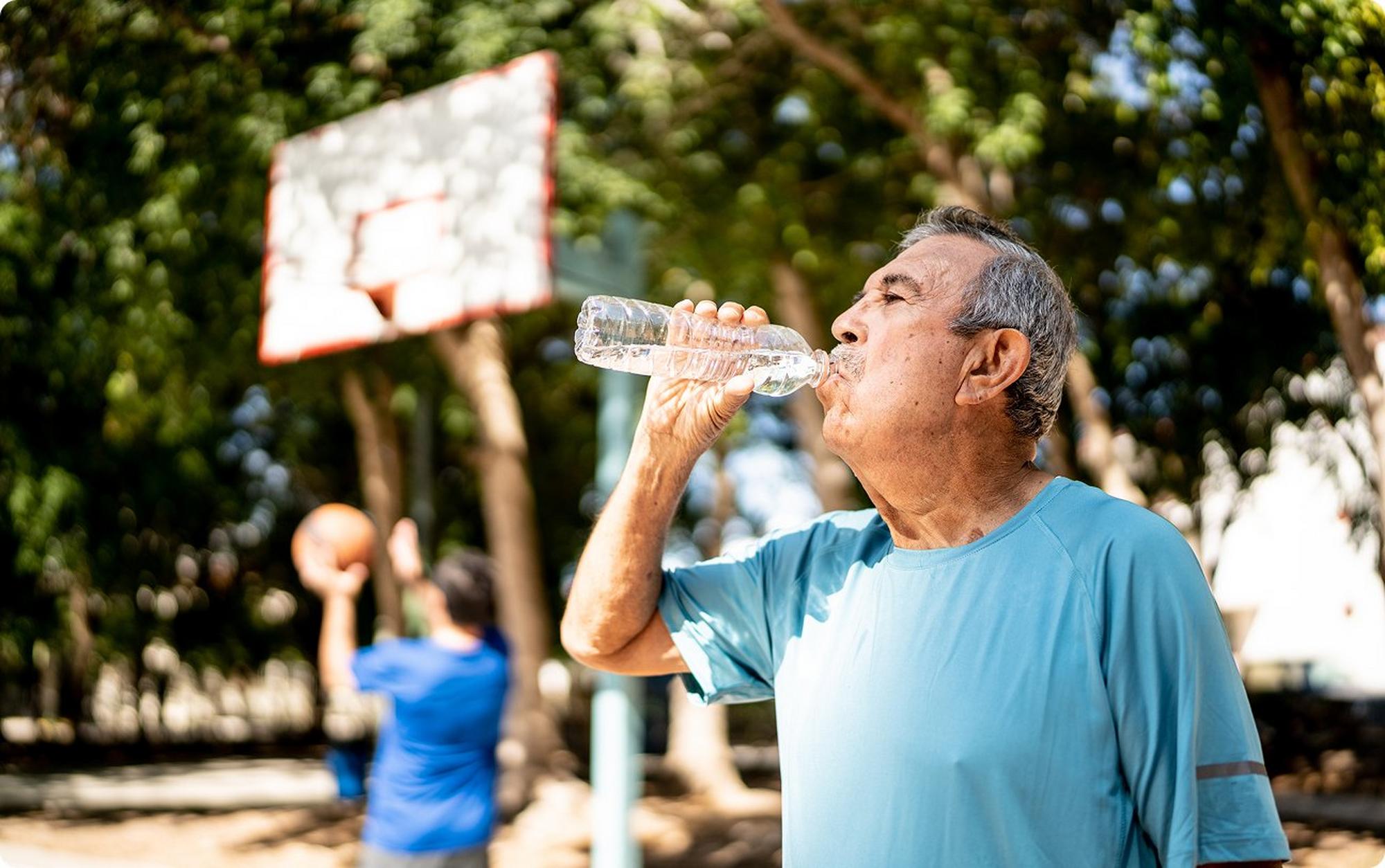 man drinking water from water bottle
