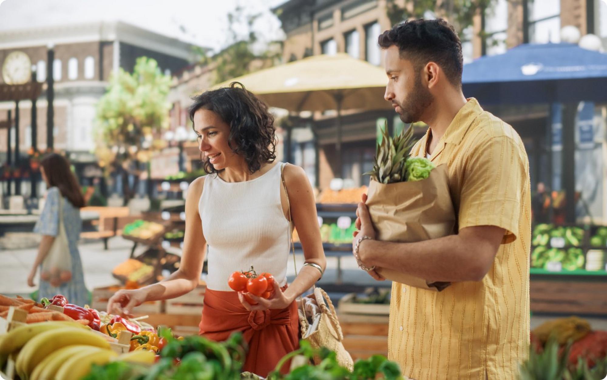 Man and woman grocery shopping at farmers market