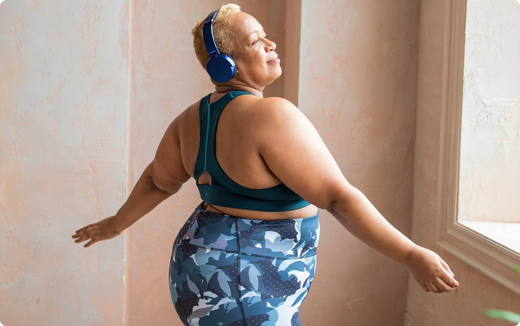 woman wearing headphones in workout outfit