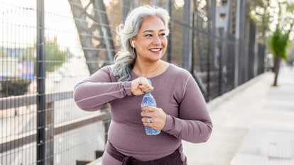 Woman drinking water on a walk