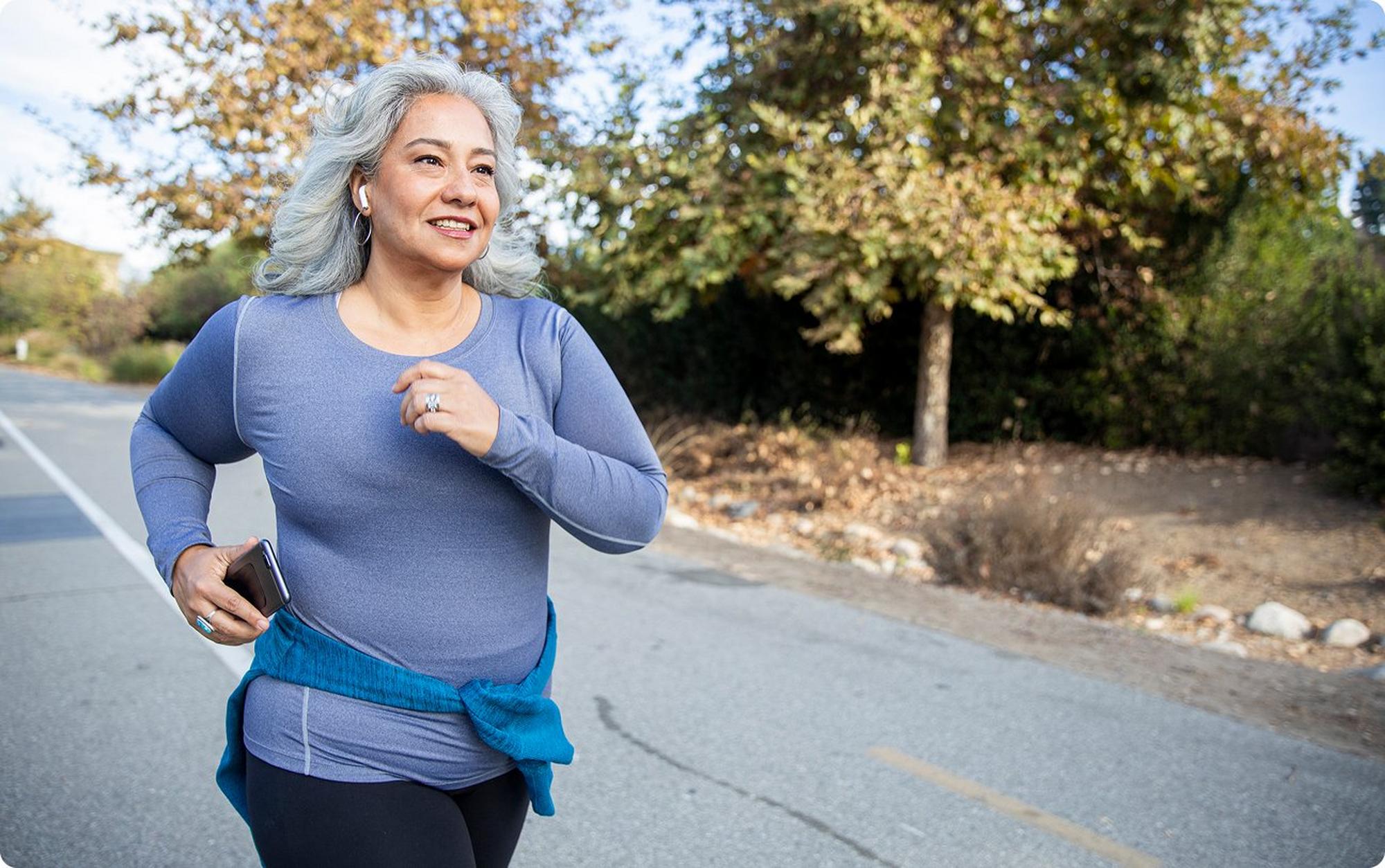Woman jogging outdoors by road