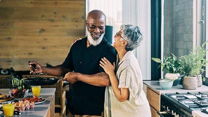 Older couple cooking a healthy meal together