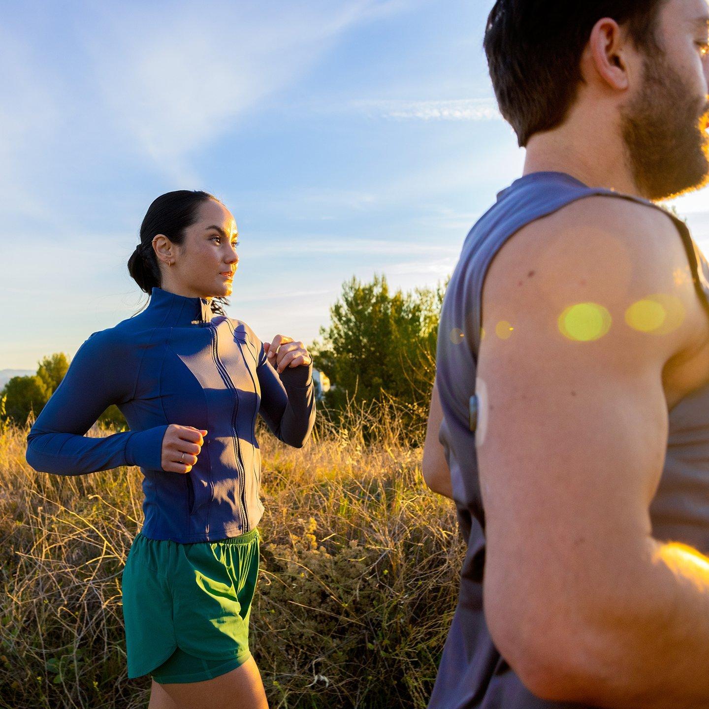 man and woman wearing stelo while jogging