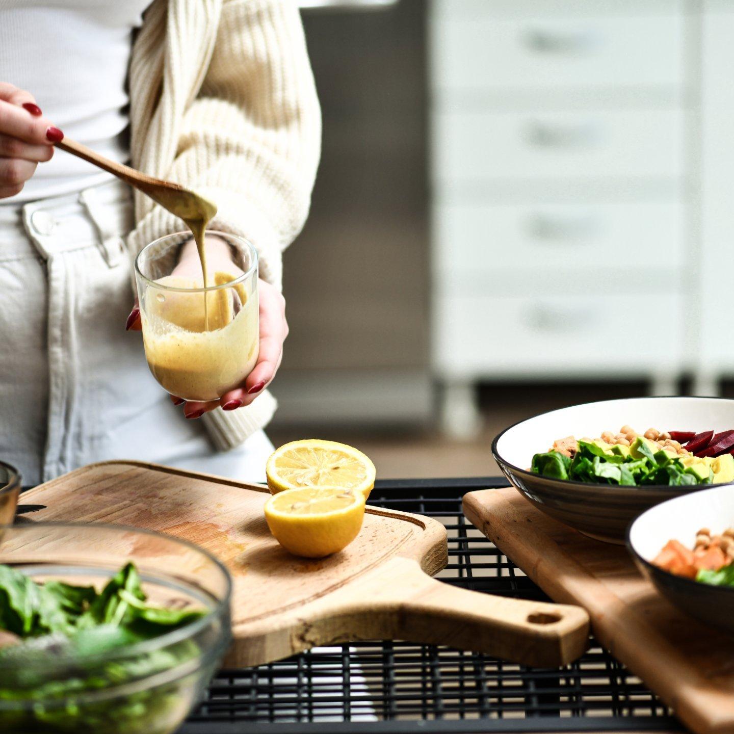 woman making homemade salad dressing