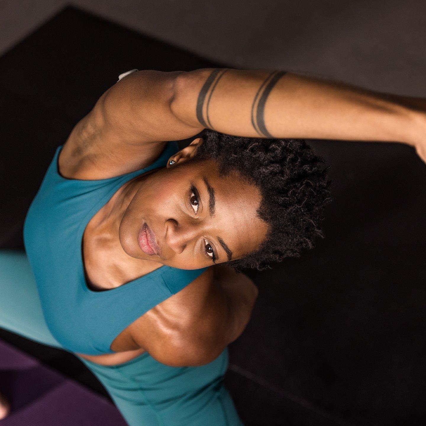 woman wearing stelo while doing a yoga pose