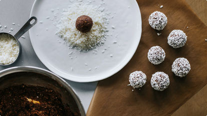 plate with coconut and an energy ball ready to roll in it