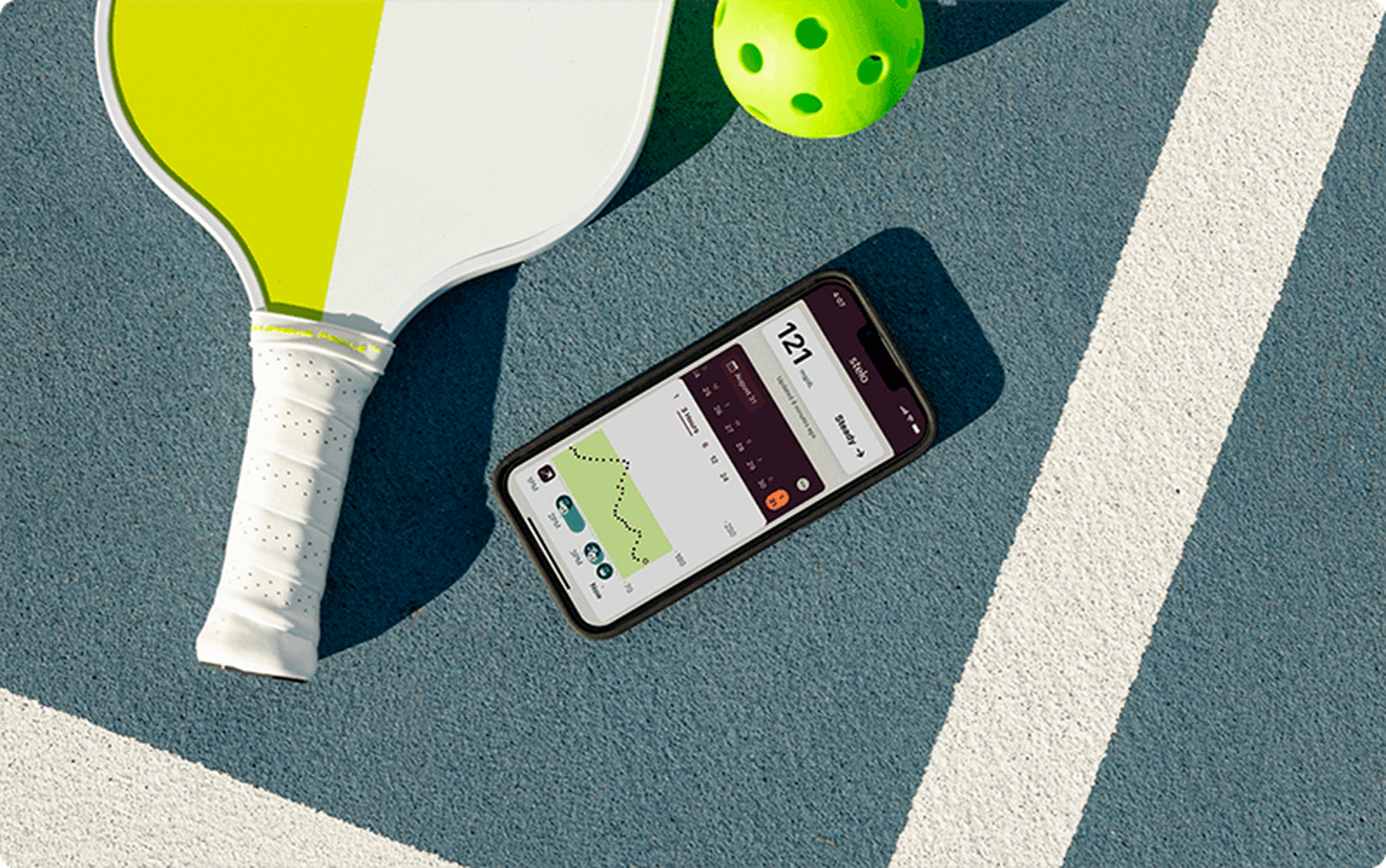 pickleball paddle and ball next to smart device showing Stelo app