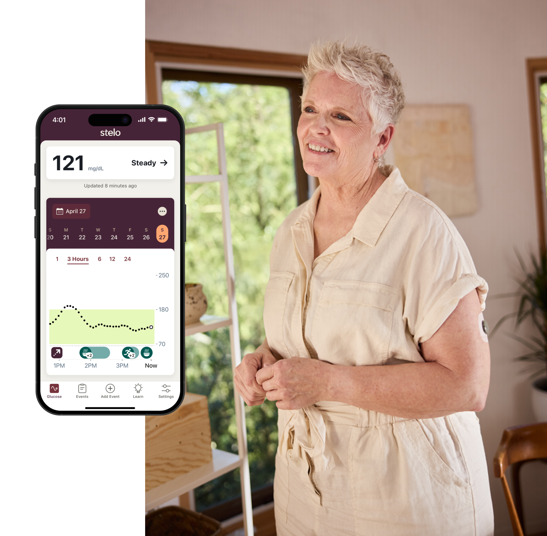elderly woman standing wearing Stelo biosensor and Stelo app on smart device