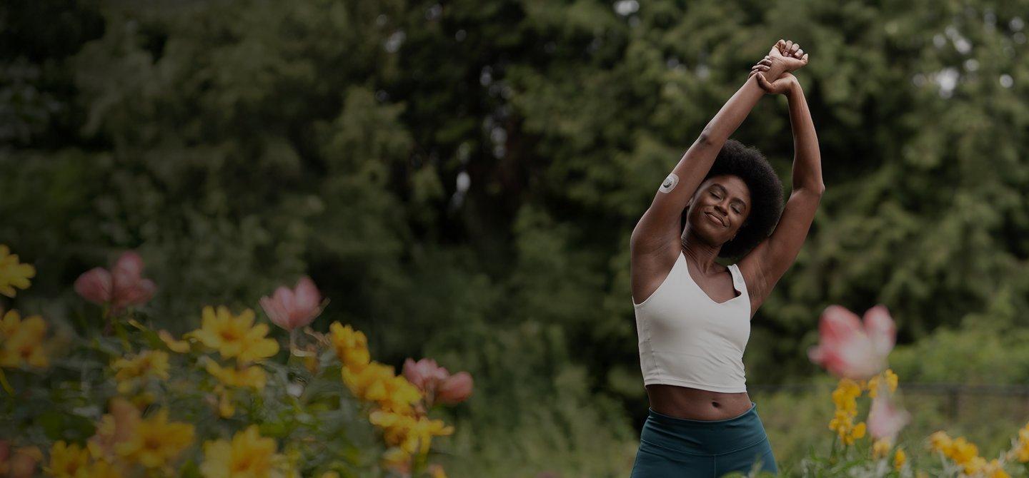 woman stretching wearing stelo glucose biosensor