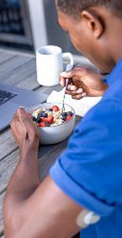 man wearing stelo biosensor while eating breakfast