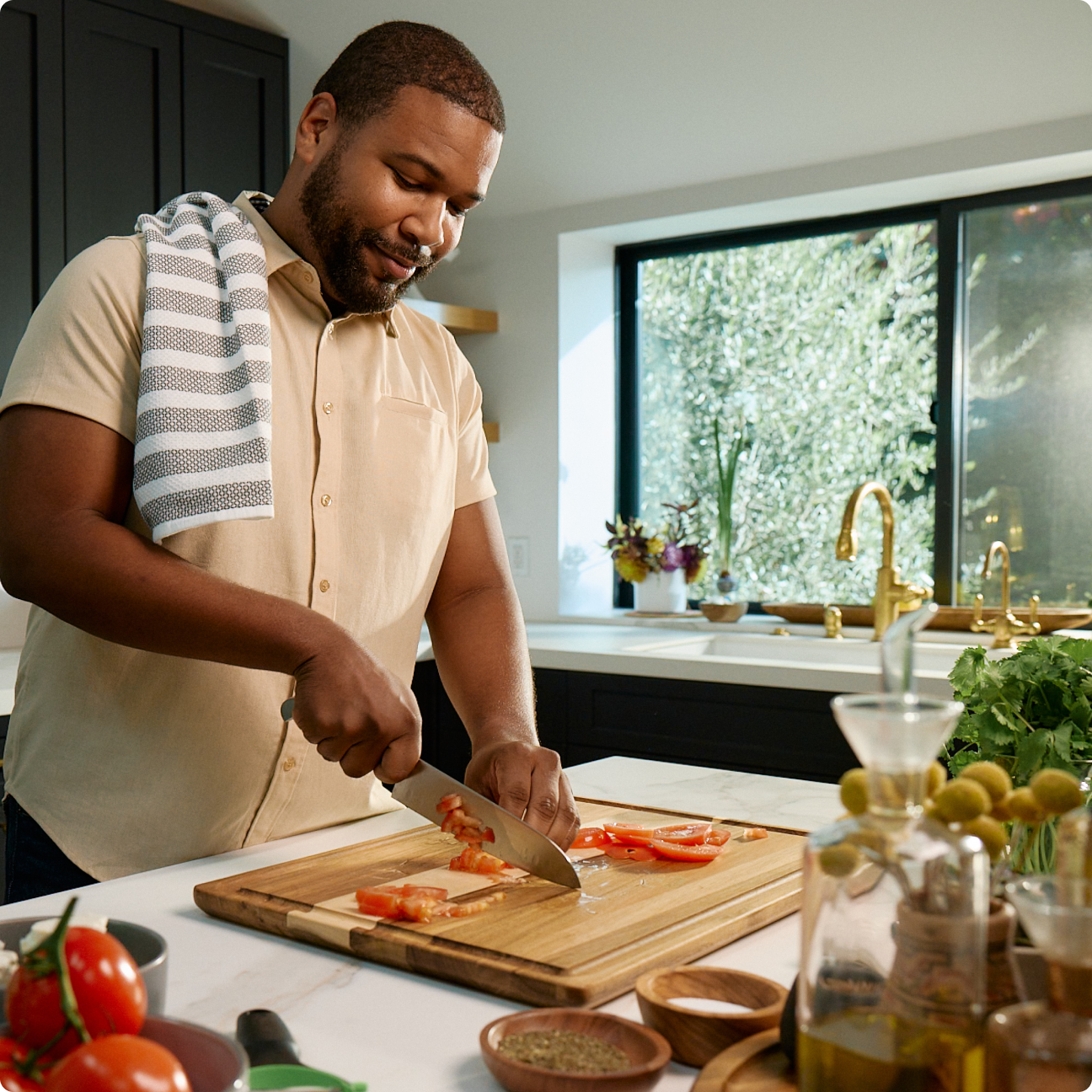 man cutting vegetables in kitchen