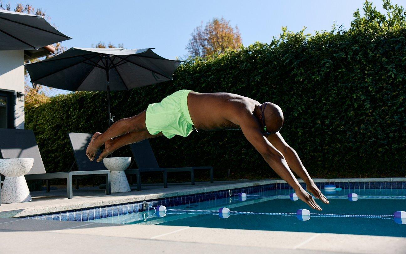 man diving into pool