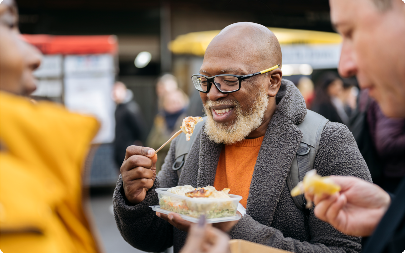 man eating dumplings outdoors