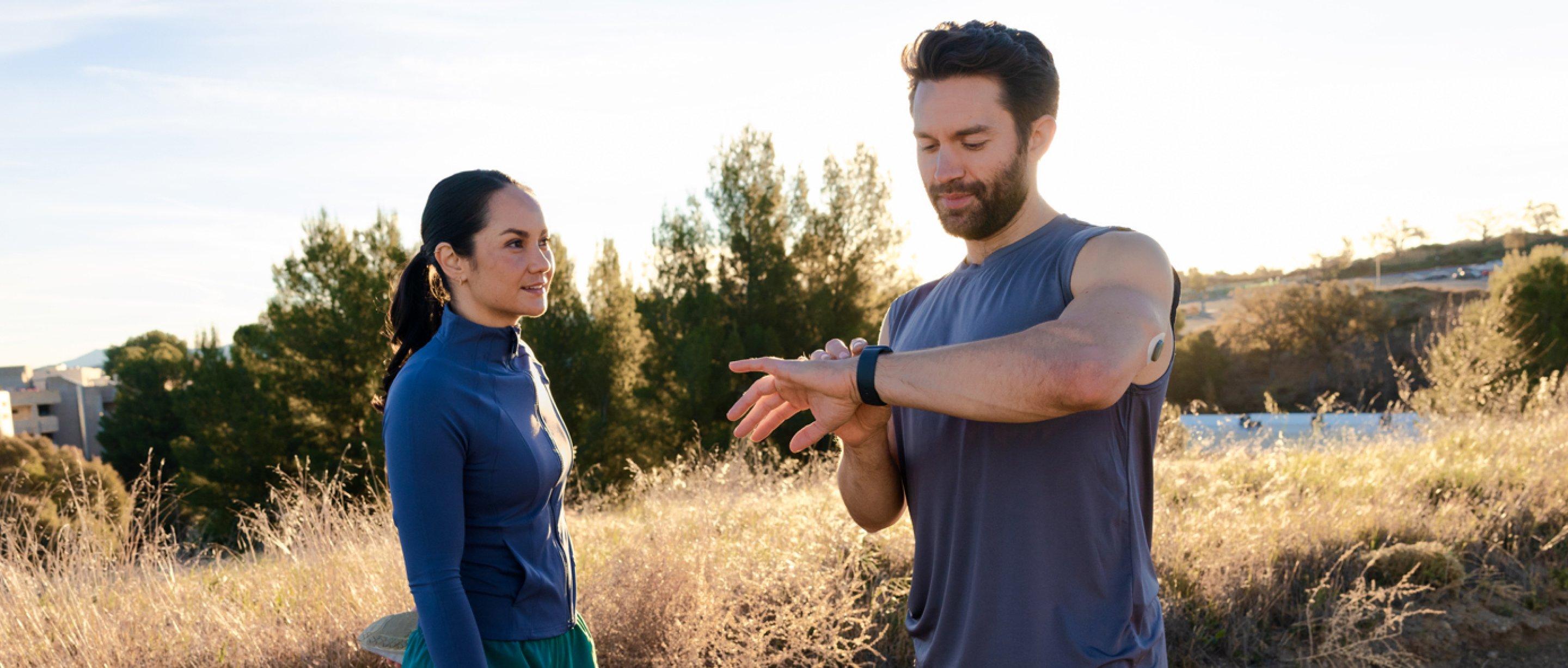 man and woman outdoors taking a break from jogging