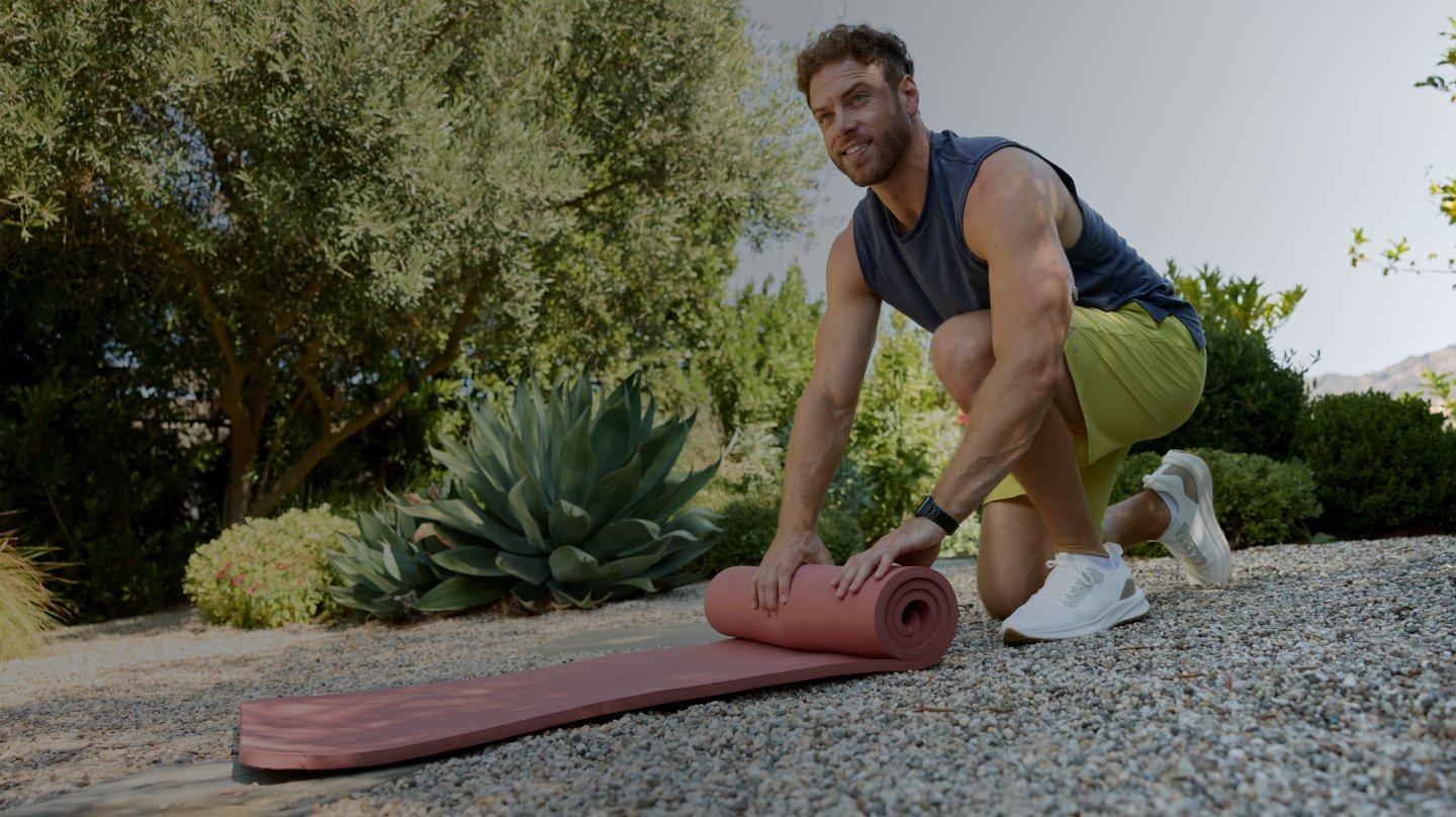 man with yoga mat wearing stelo