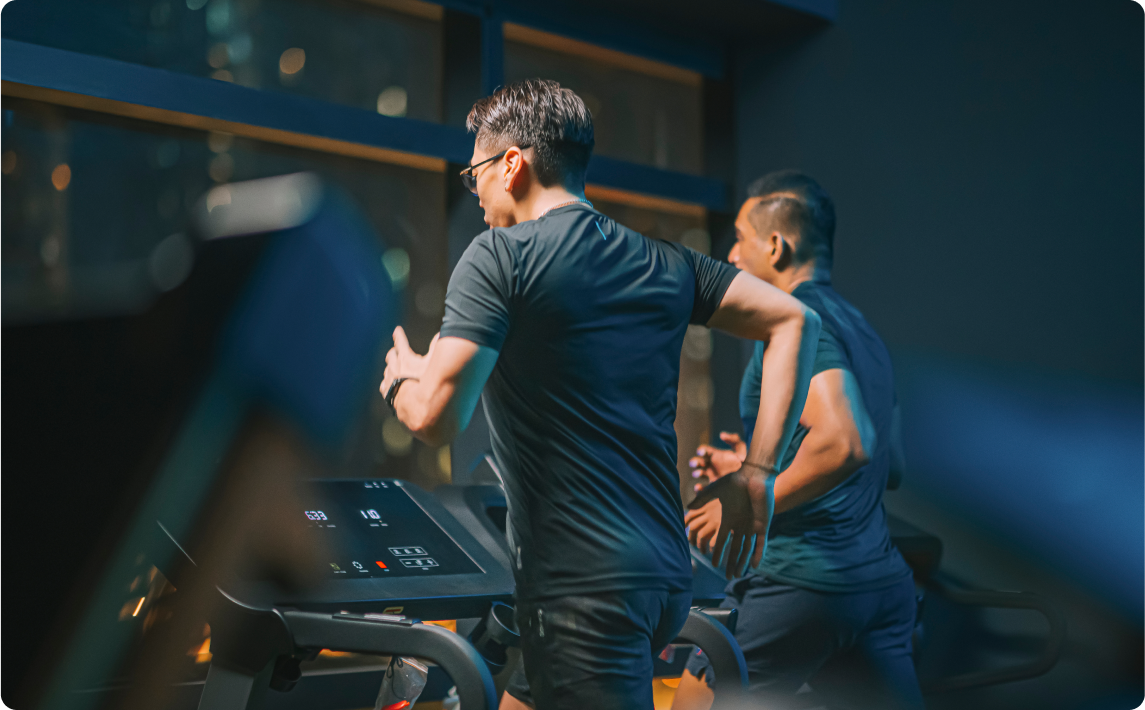 Men running on treadmill at gym