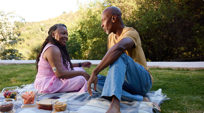 Senior couple having picnic outdoors