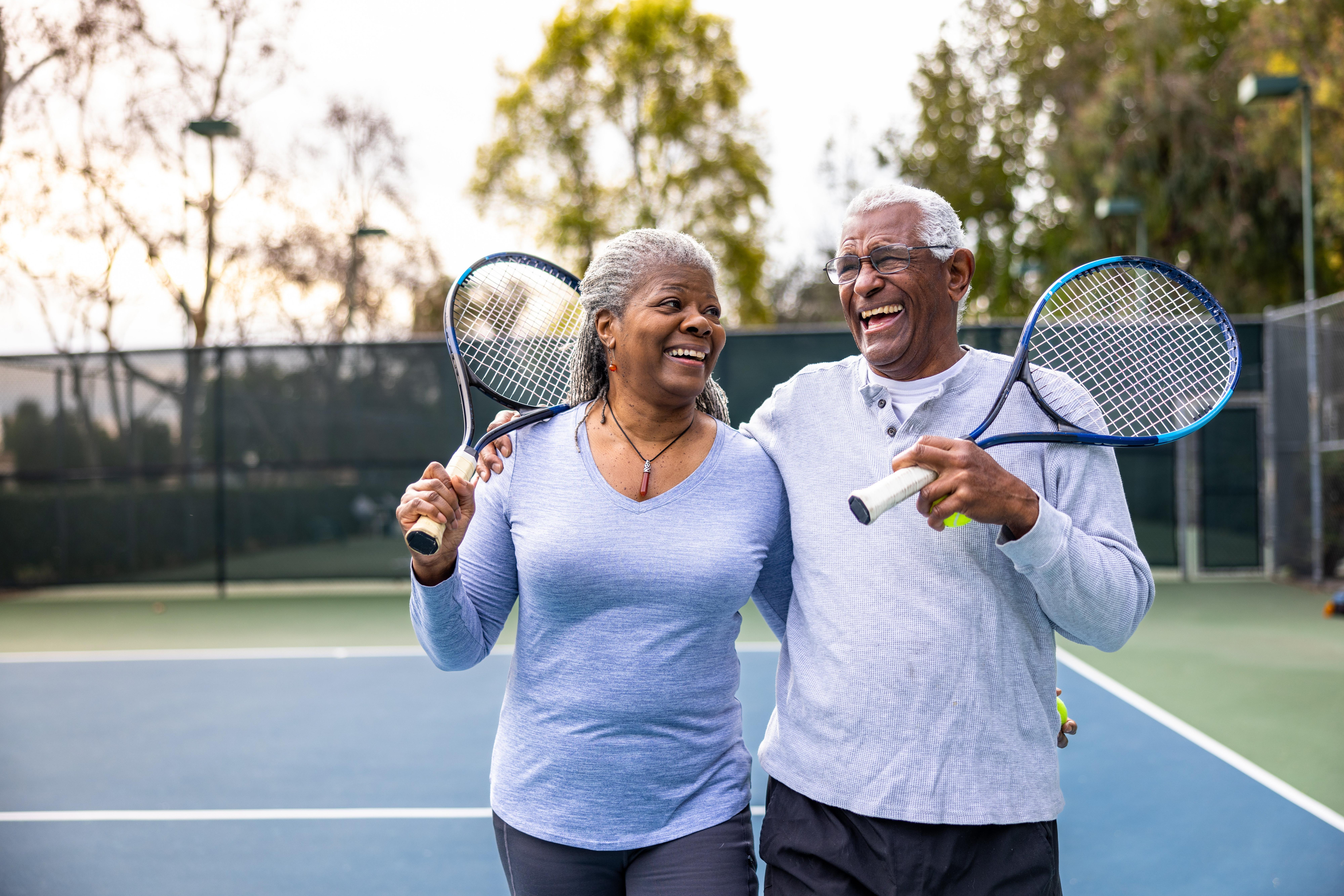 senior couple playing tennis