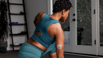 Woman doing yoga with Stelo on back of arm