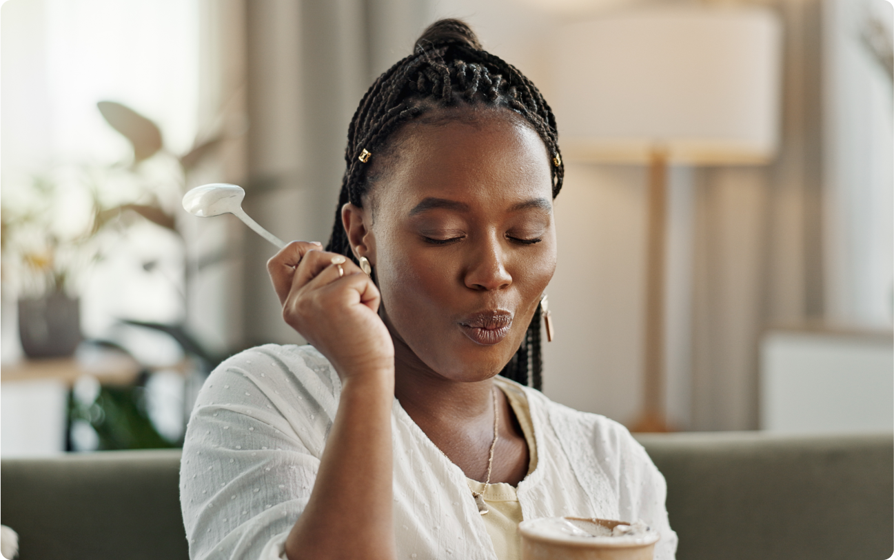 woman eating ice cream on couch