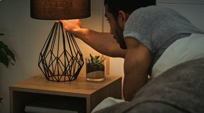 Man turning off the bedside light