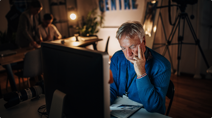 Man sitting at computer at night