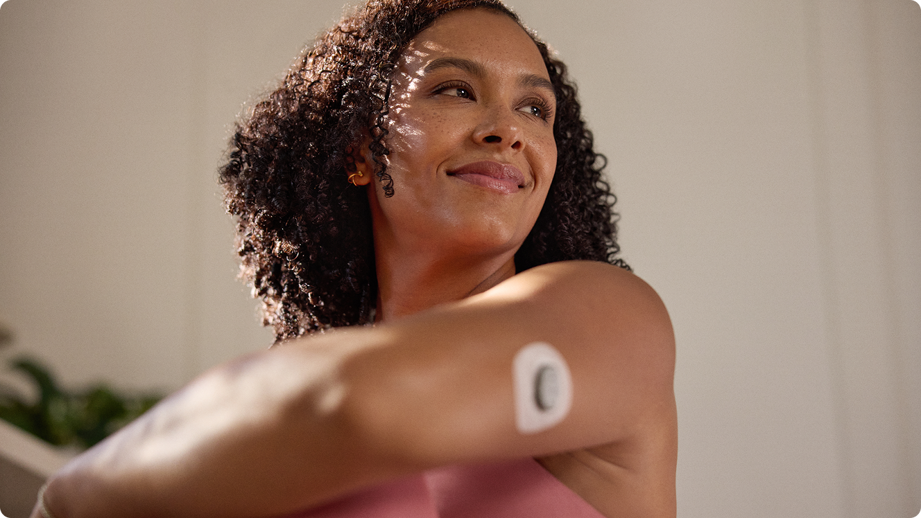 Woman exercising and wearing Stelo glucose biosensor on the back of her arm.