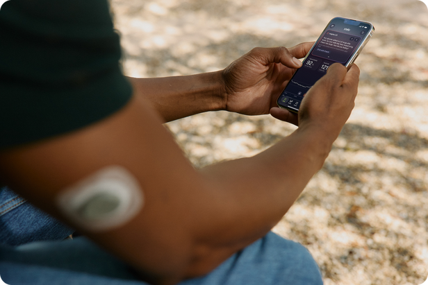 Man wearing Stelo sensor checking readings on phone