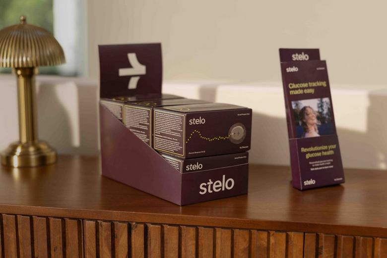 Stelo product in wholesale quantity displayed on counter next to product brochure. 