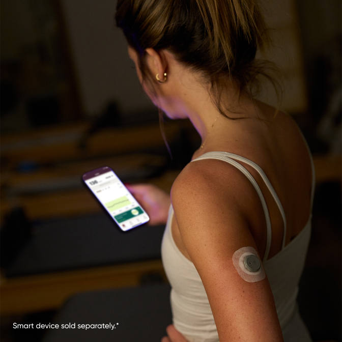 woman looking at stelo app on smartphone