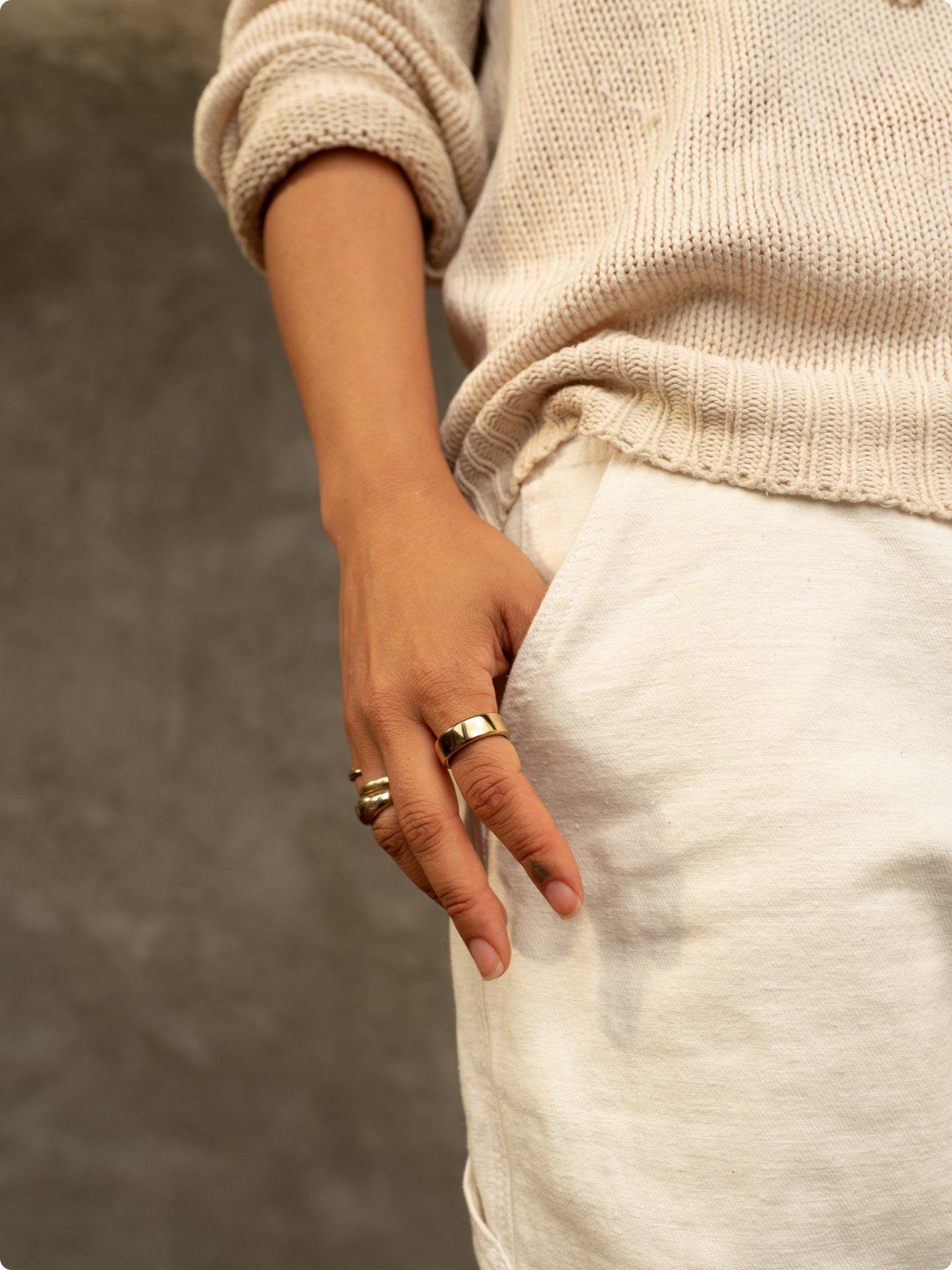 person wearing oura ring with hand partially in pocket