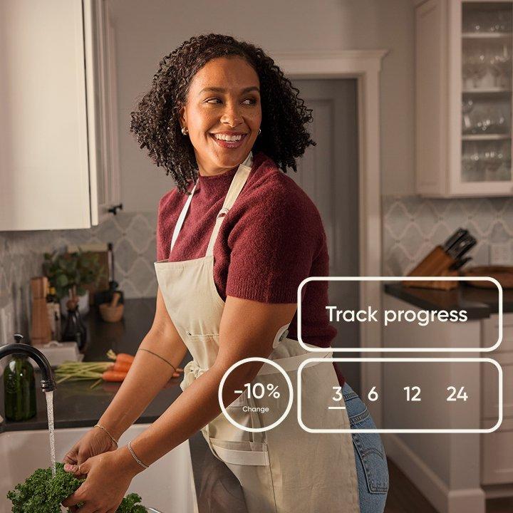 woman in kitchen washing vegetables wearing stelo glucose biosensor