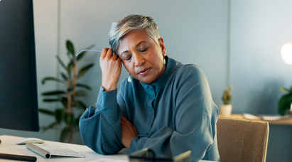 woman sitting at her desk, stressed out