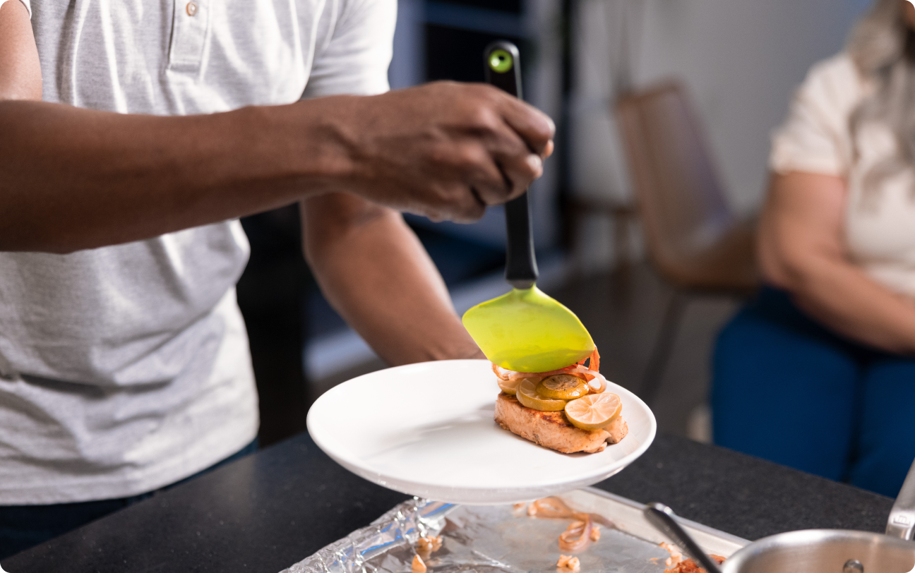 Man putting food on plate
