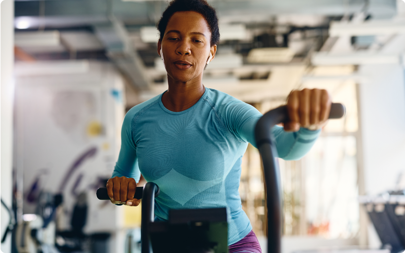 woman exercising on fitness bike at gym