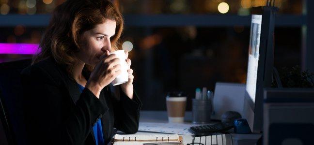 woman sipping coffee at night