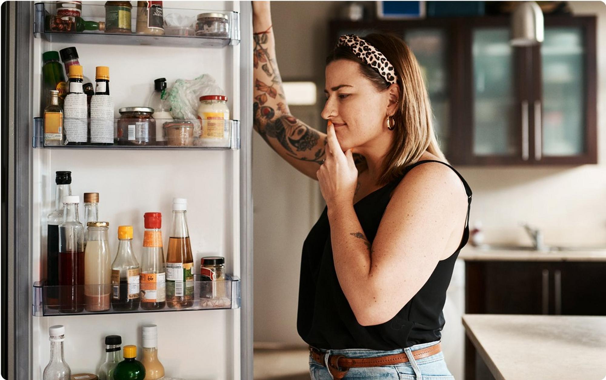 woman standing at fridge