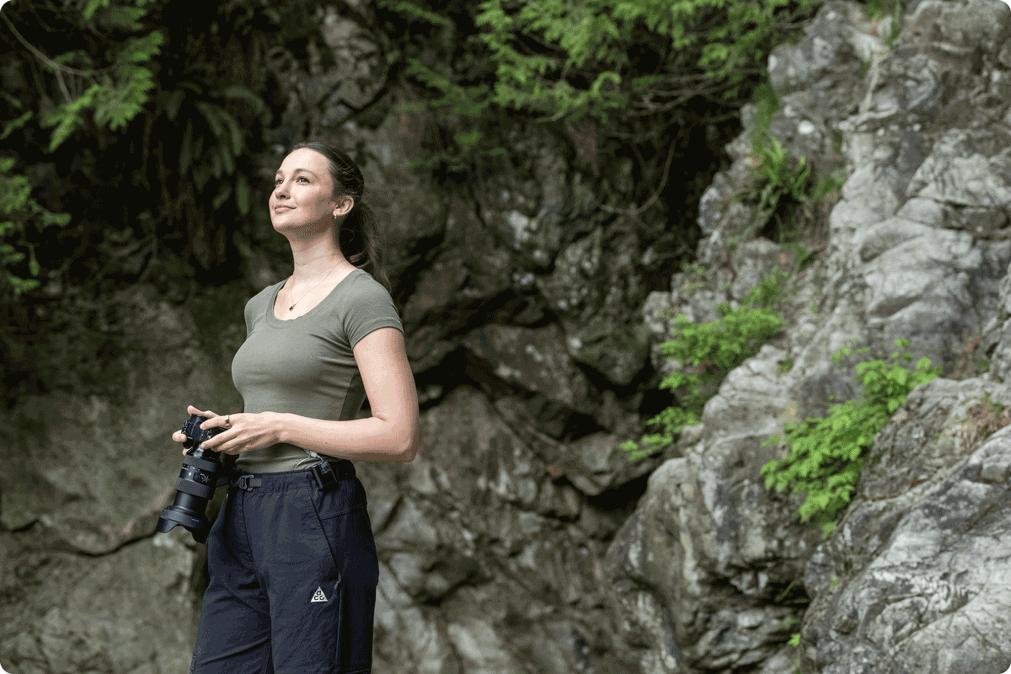 Woman standing in nature with her camera