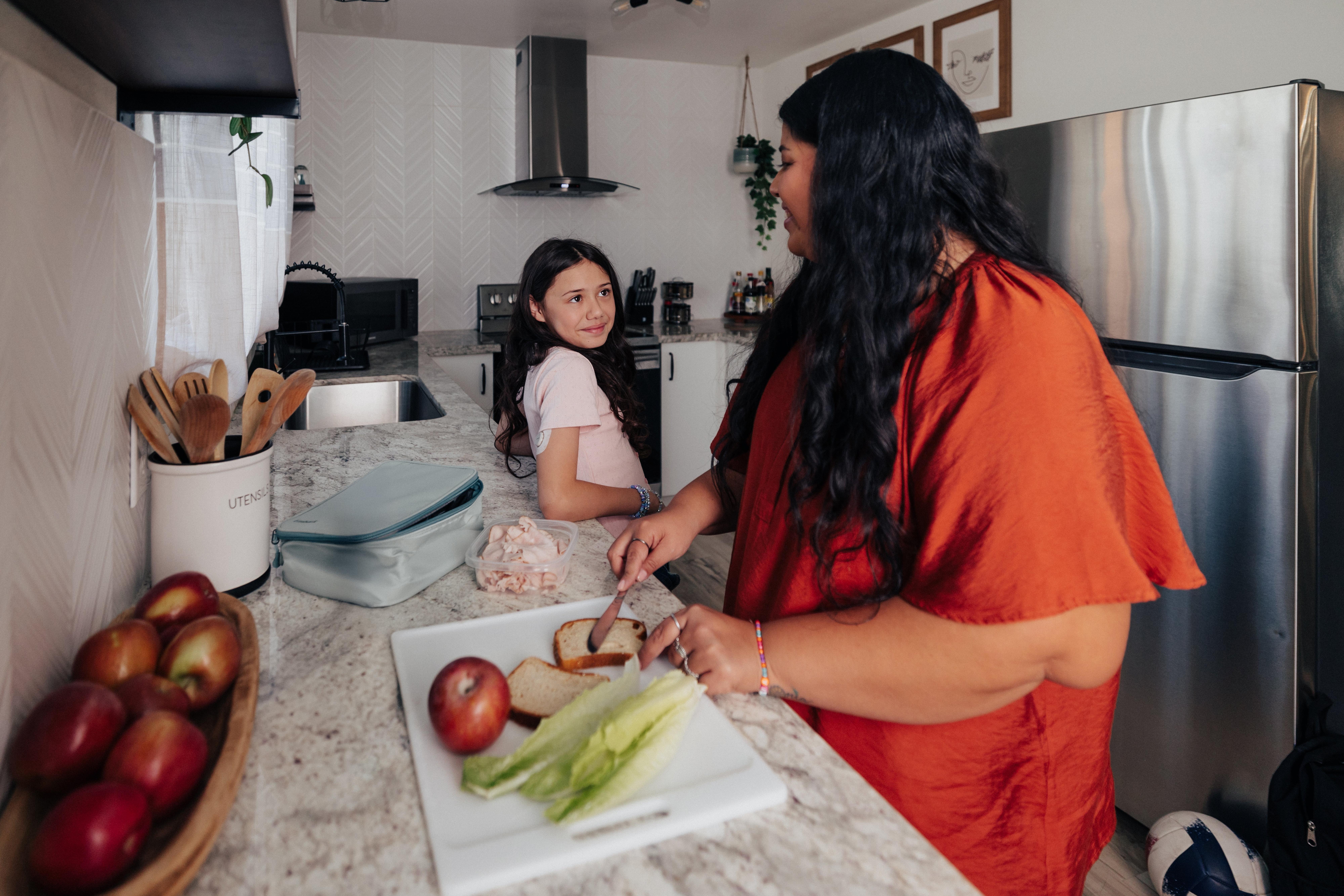 child and a mom preparing a lunch