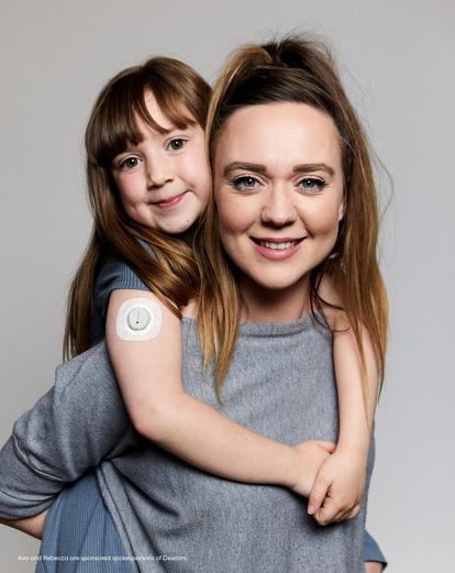 Dexcom Warrior Ava with CGm on arm with her Mum