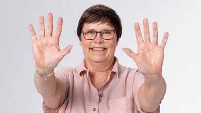 Woman holding up ten fingers
