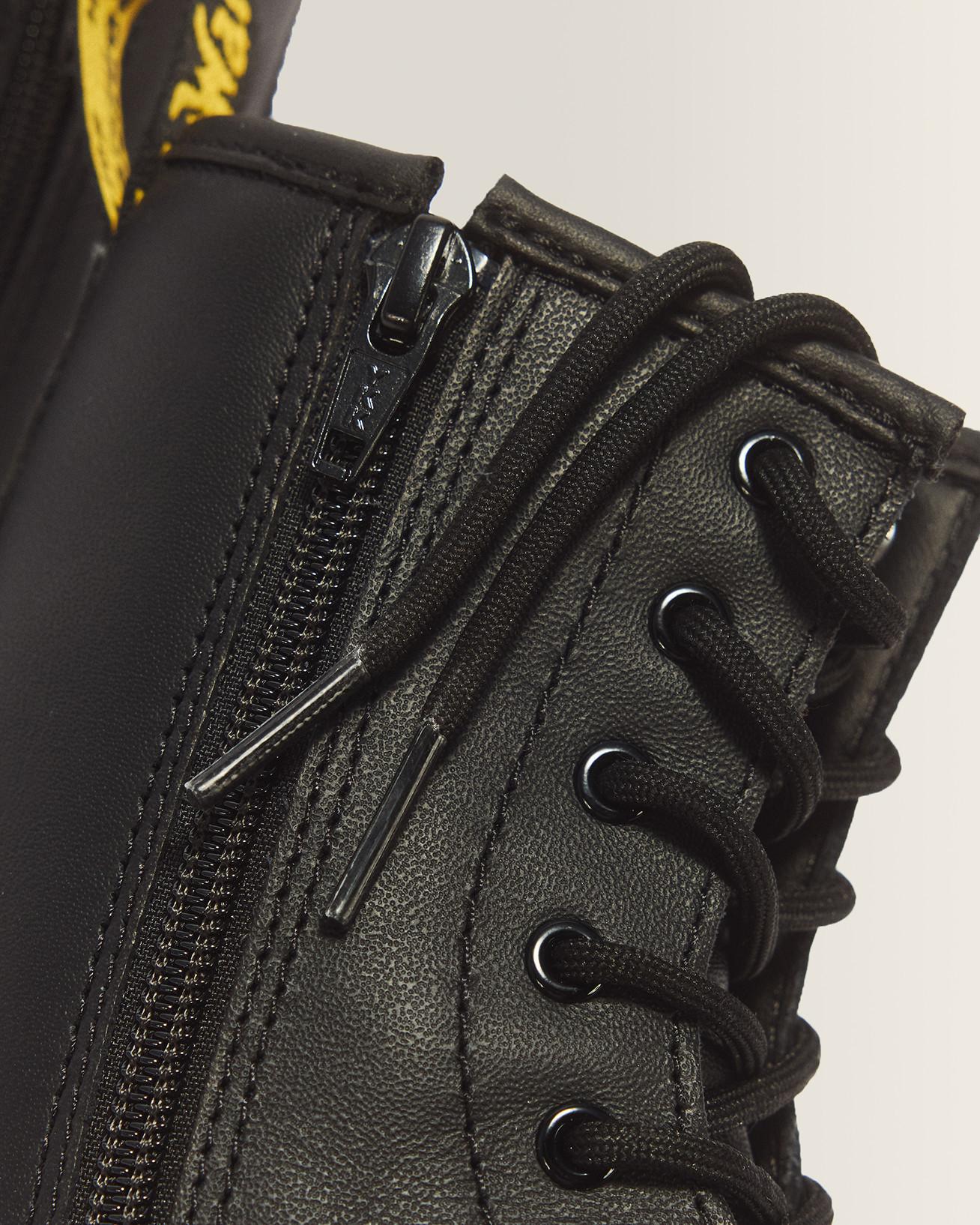 Close-up of black leather boot with side zip, black laces and eyelets