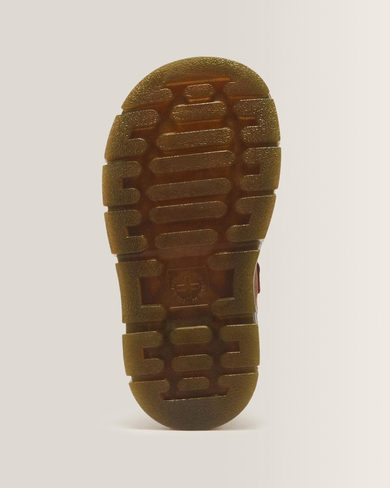 Translucent amber rubber outsole with rugged tread blocks