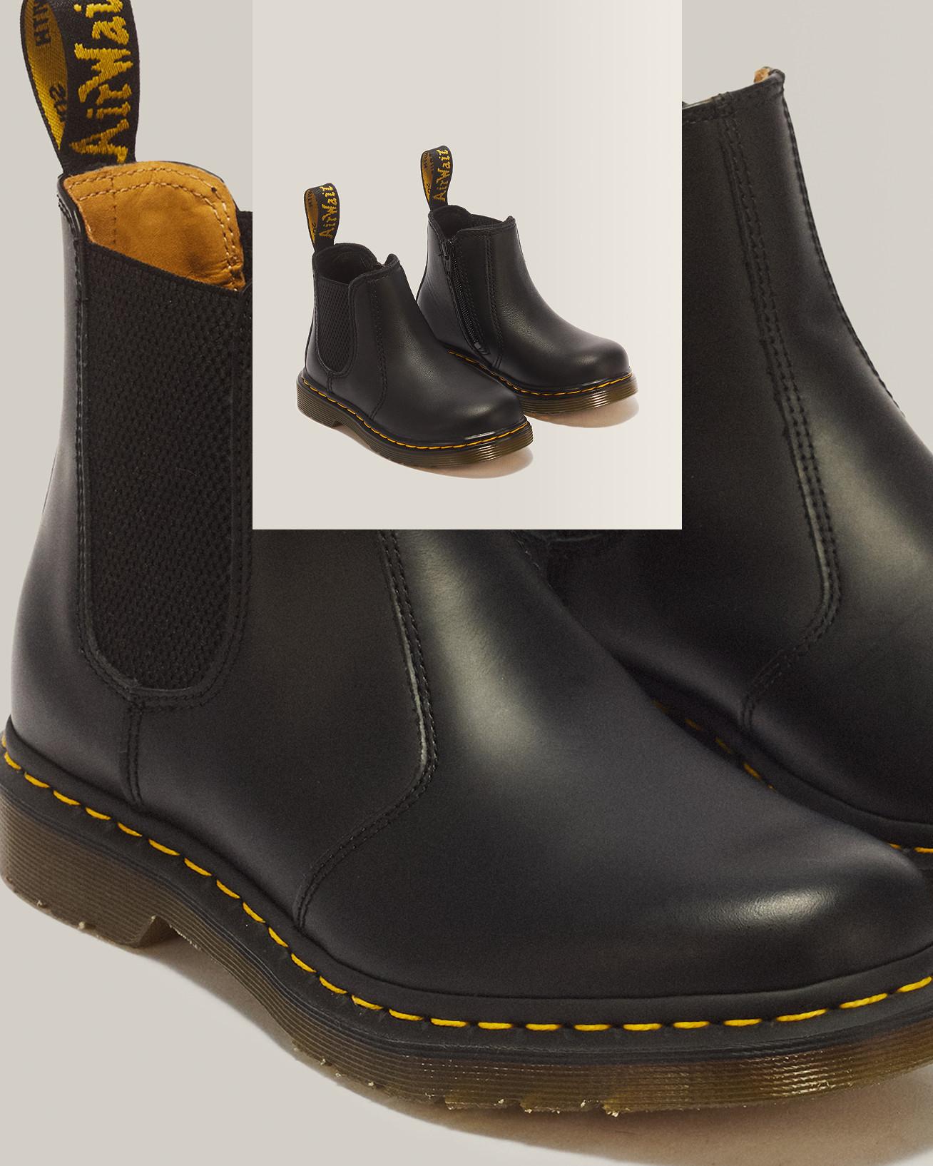 Black leather Chelsea boots with elastic side panels, yellow welt stitching and pull tabs